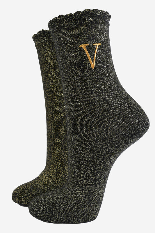 black ankle socks with a scalloped cuff, with an all over gold glitter sparkle and an embroidered gold letter v on the ankle