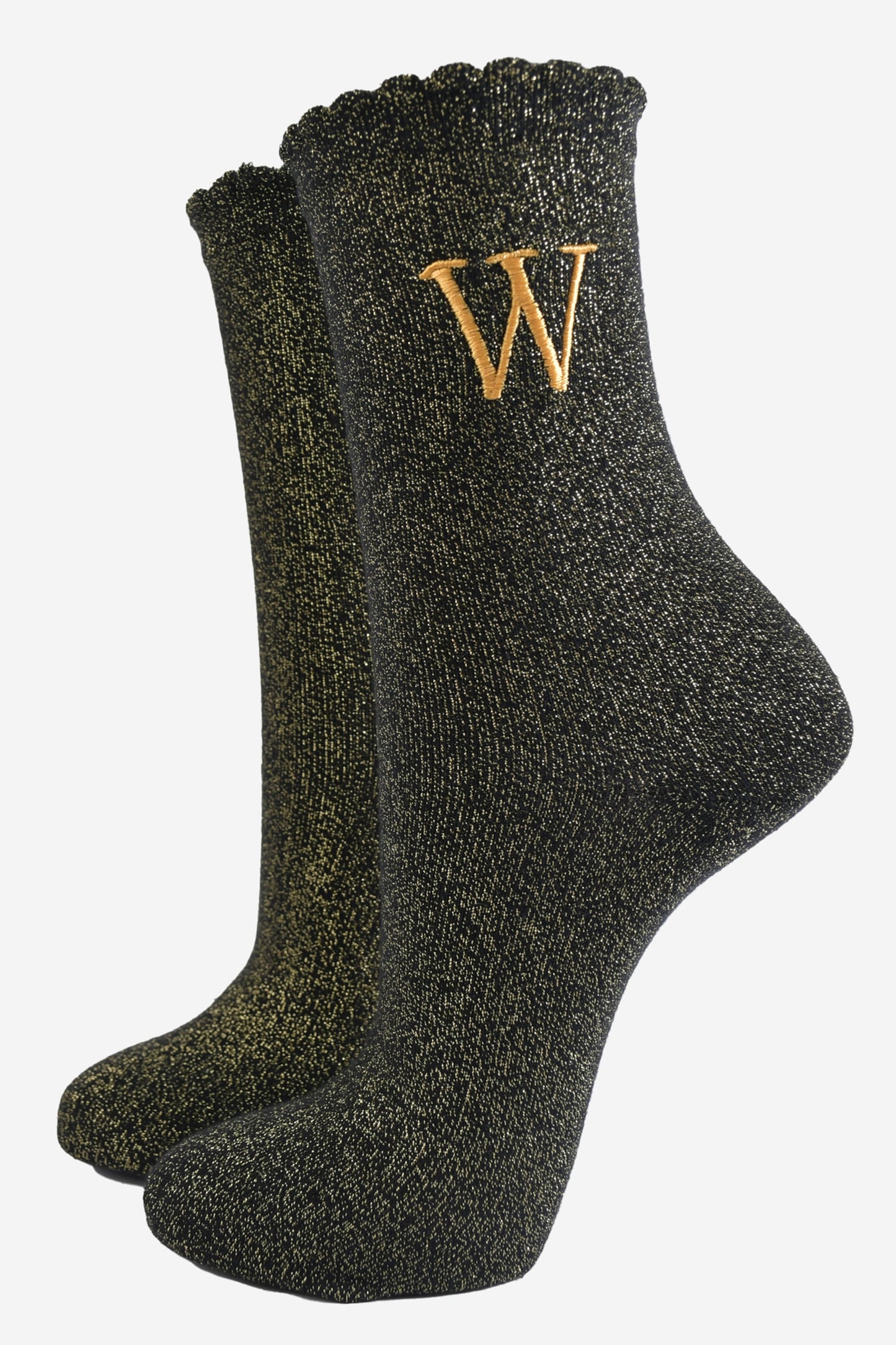 black ankle socks with a scalloped cuff, with an all over gold glitter sparkle and an embroidered gold letter w on the ankle