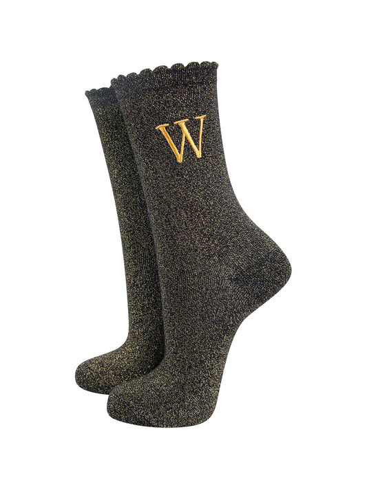 black ankle socks with a scalloped cuff, with an all over gold glitter sparkle and an embroidered gold letter w on the ankle