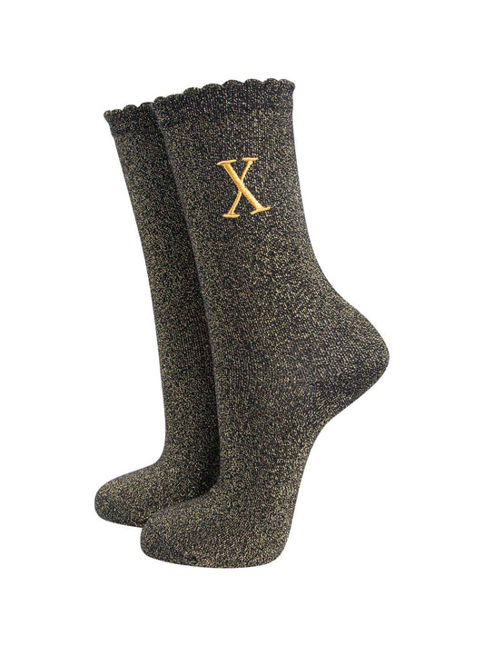 black ankle socks with a scalloped cuff, with an all over gold glitter sparkle and an embroidered gold letter x on the ankle