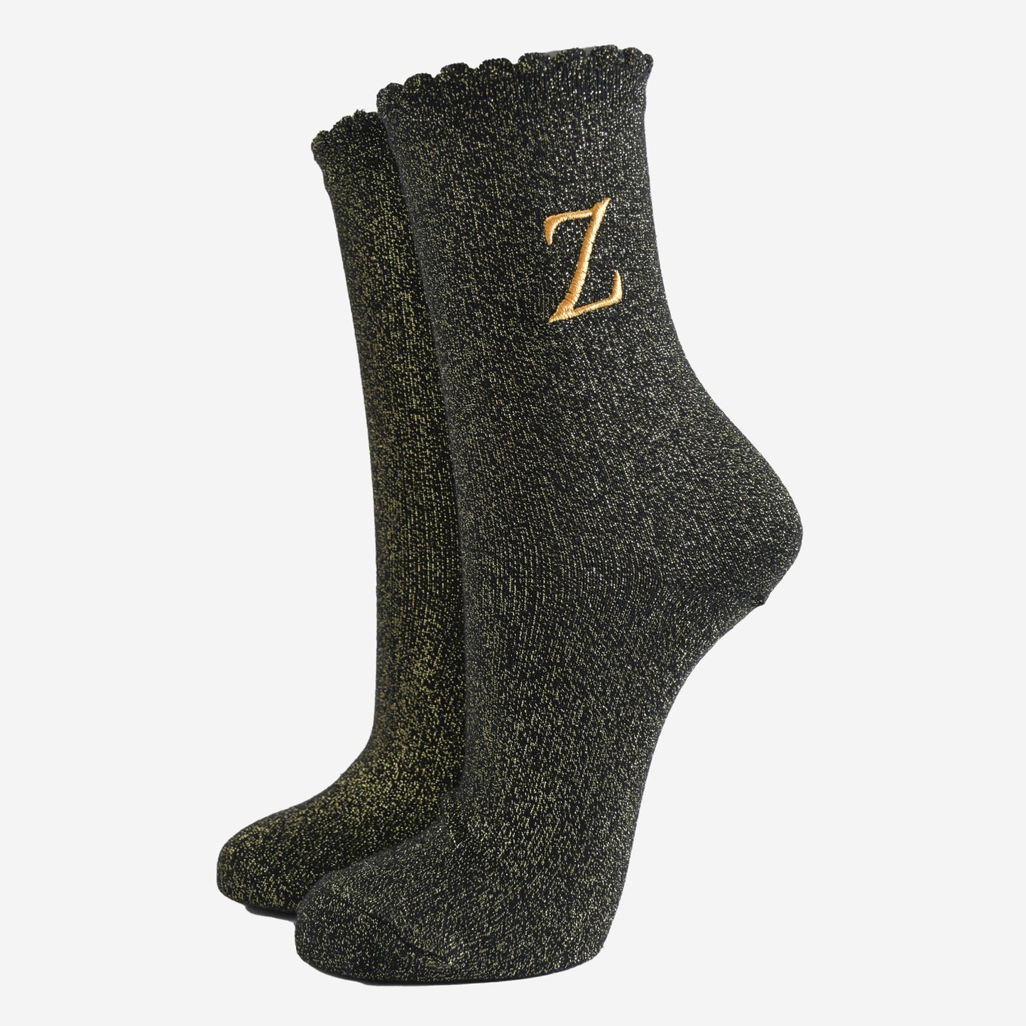 black ankle socks with a scalloped cuff, with an all over gold glitter sparkle and an embroidered gold letter z on the ankle