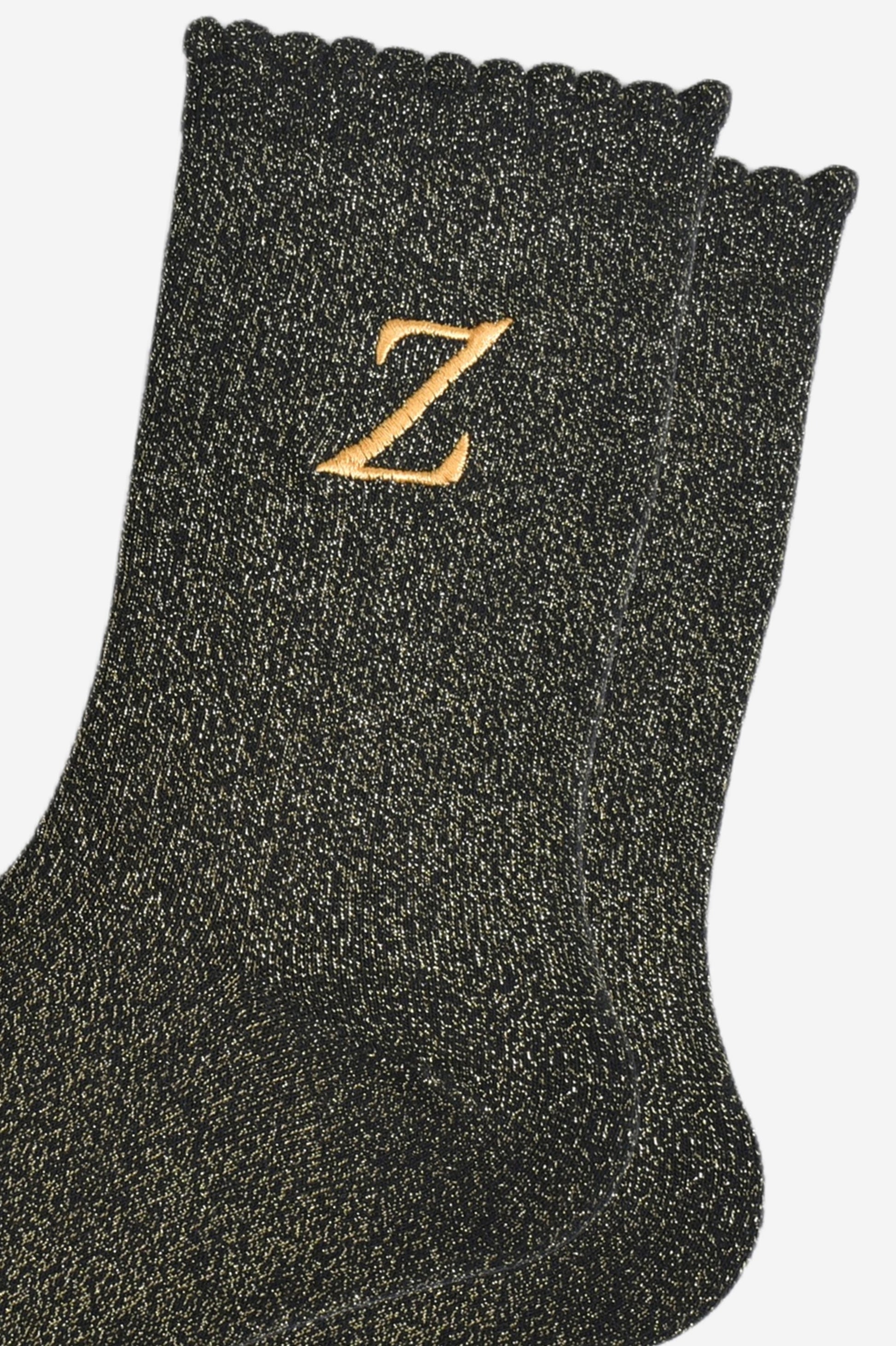 close up of the gold embroidered capital letter z on the ankle of the socks