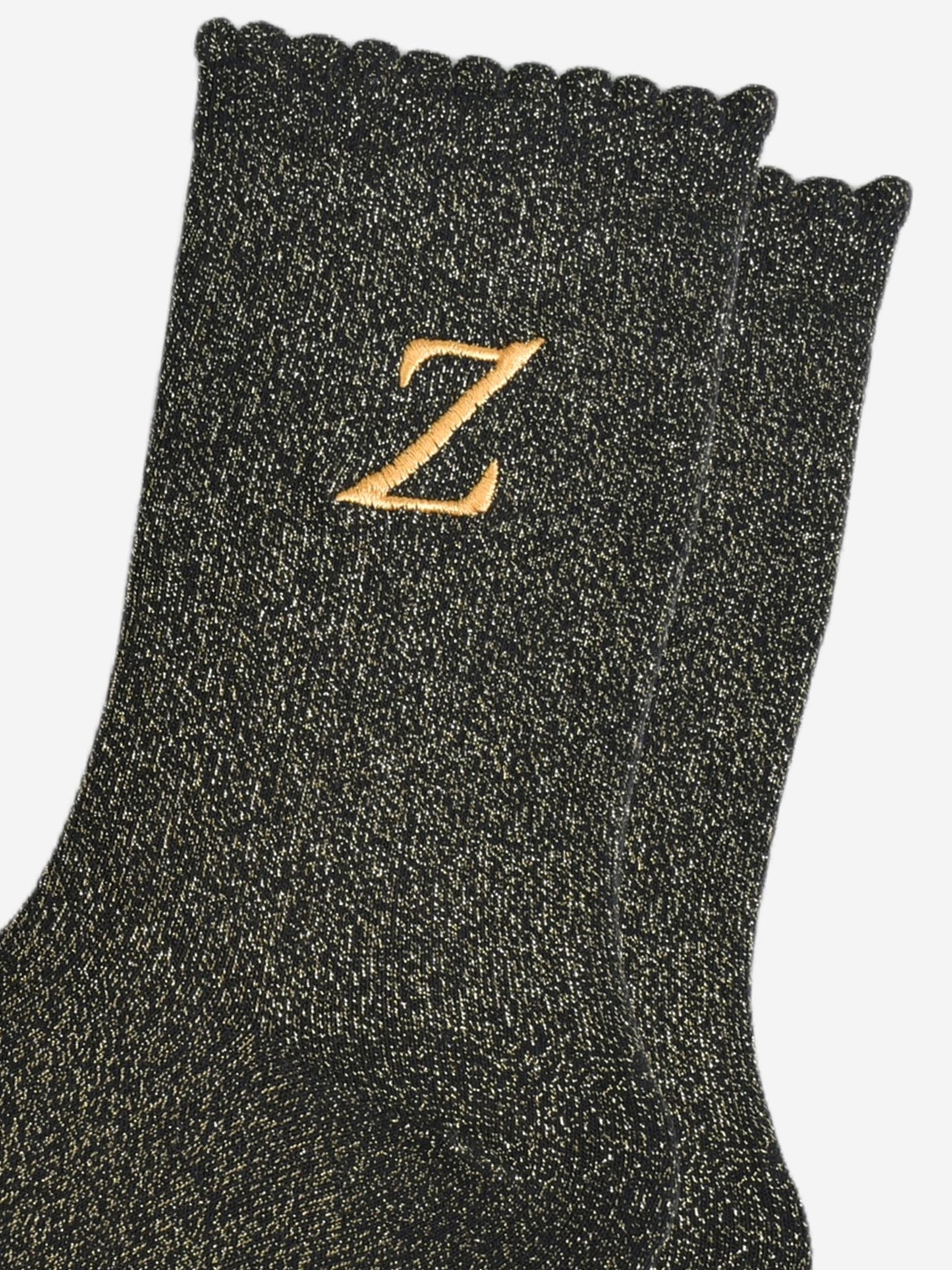 close up of the gold embroidered capital letter z on the ankle of the socks