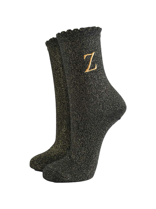 black ankle socks with a scalloped cuff, with an all over gold glitter sparkle and an embroidered gold letter z on the ankle