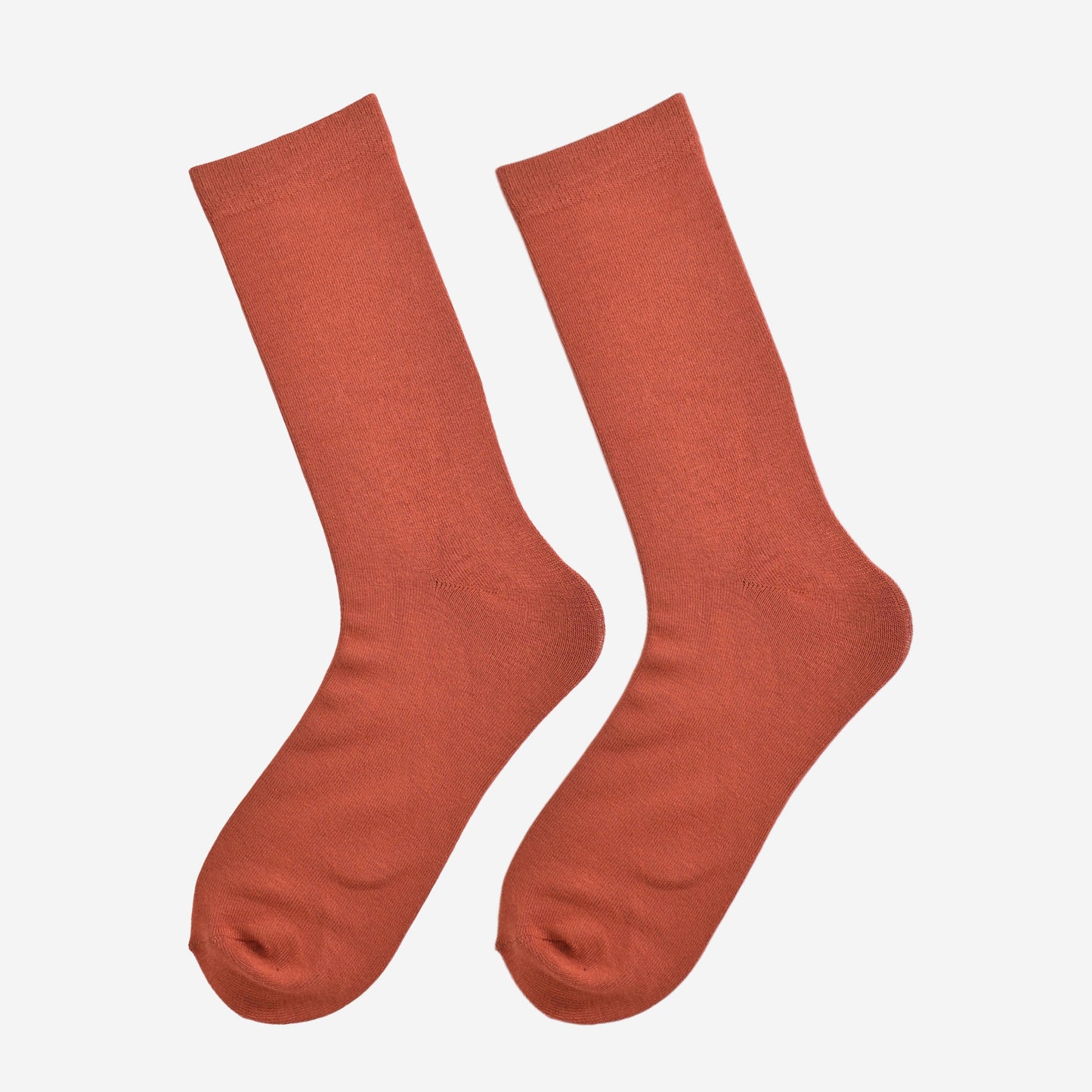 rust orange bamboo socks laying flat, showing the all over consistent colour