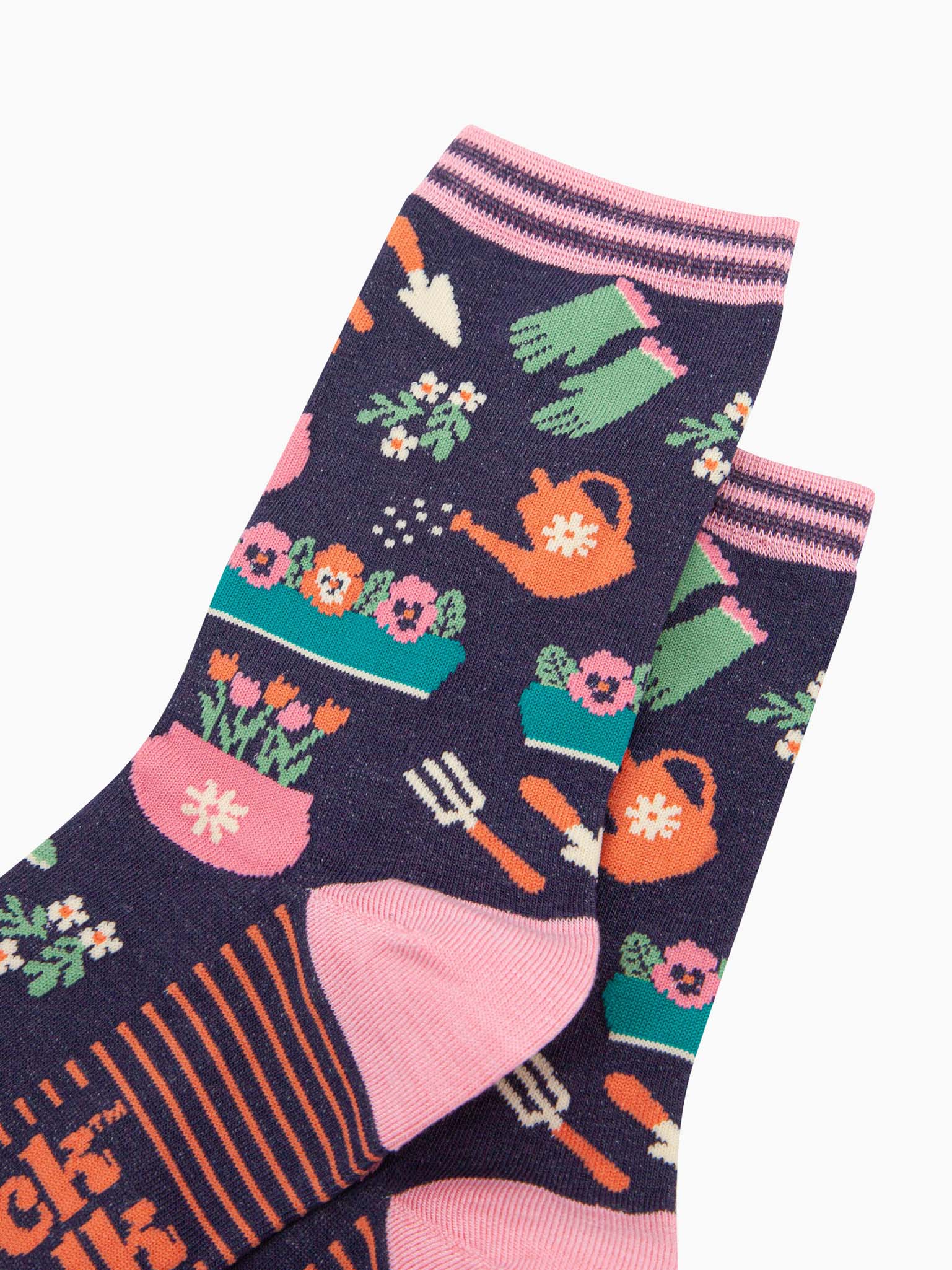 womens-bamboo-socks-navy-gardening-close-up-of-the-design-showing-wateringcans-gloves-tools-and-flower-pots