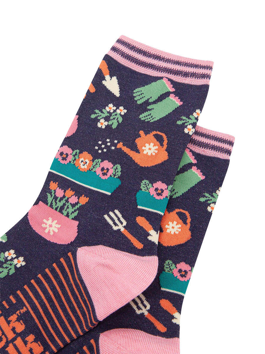 womens-bamboo-socks-navy-gardening-close-up-of-the-design-showing-wateringcans-gloves-tools-and-flower-pots
