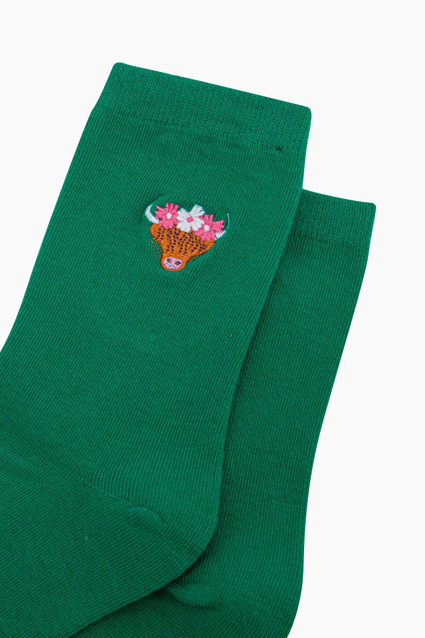 womens-embroidered-socks-green-highland-cow-close-up-coo-wearing-pink-and-white-floral-crown-cow-is-orange-with-long-hair