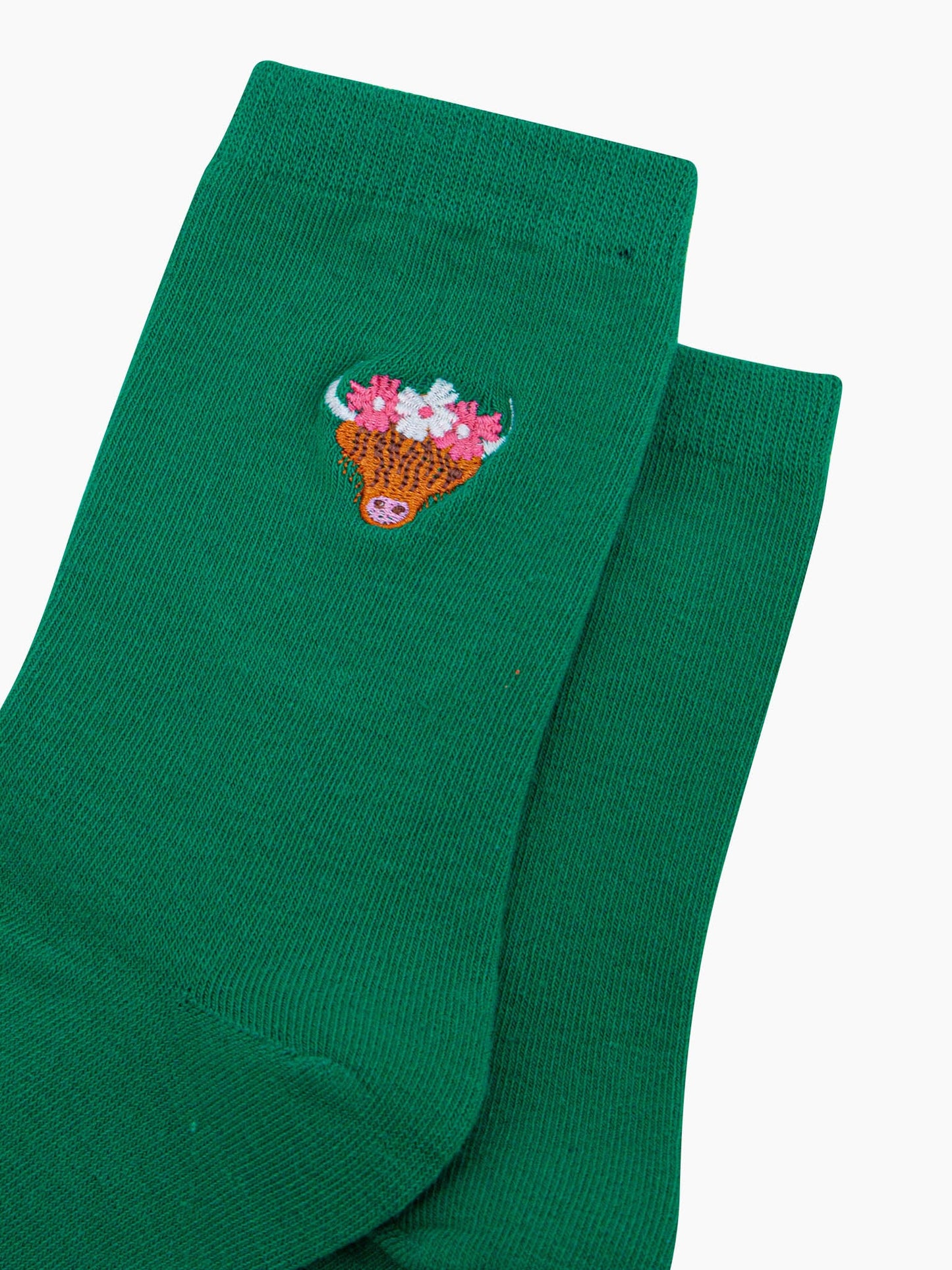 womens-embroidered-socks-green-highland-cow-close-up-coo-wearing-pink-and-white-floral-crown-cow-is-orange-with-long-hair