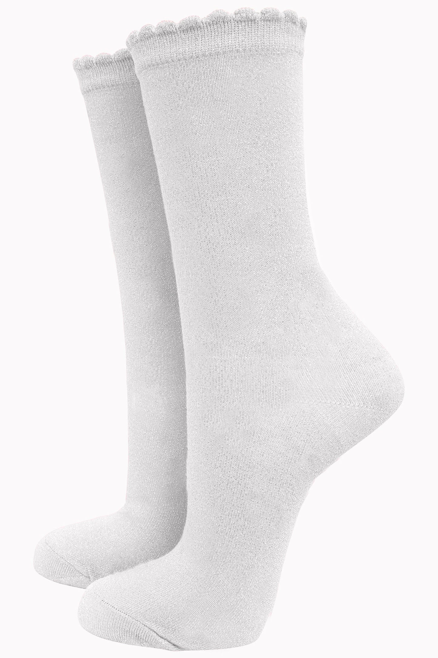 white cotton socks with an all over silver glitter shimmer, the socks have a scalloped cuff edge