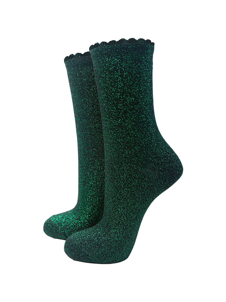 black cotton socks with an all over bright green glitter shimmer, the socks have a scalloped cuff edge