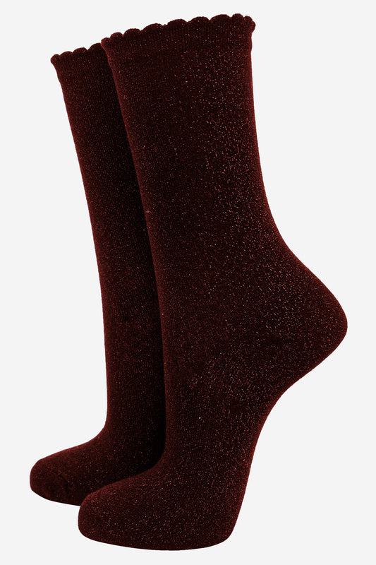 red cotton socks with an all over glitter shimmer, the socks have a scalloped cuff edge