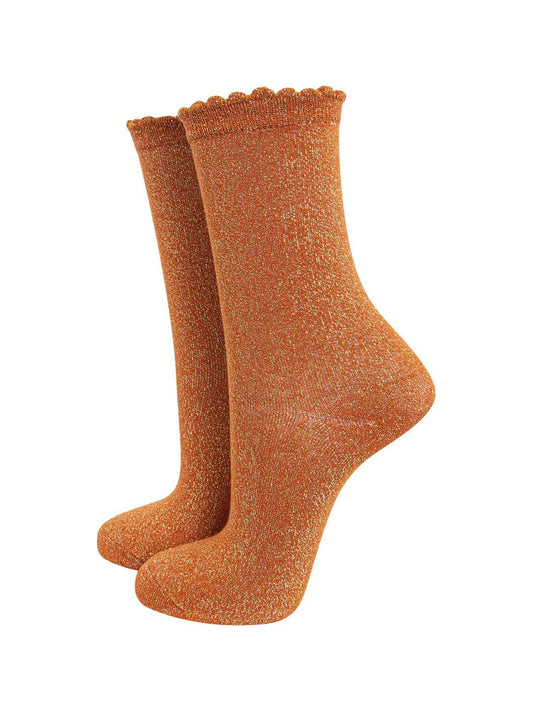 burnt orange cotton socks with an all over silver glitter shimmer, the socks have a scalloped cuff edge