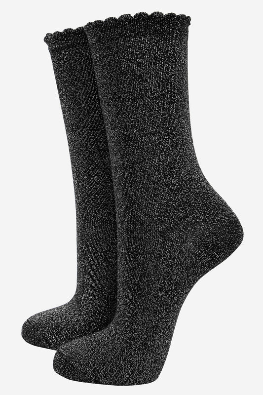 black cotton socks with an all over silver glitter shimmer, the socks have a scalloped cuff edge