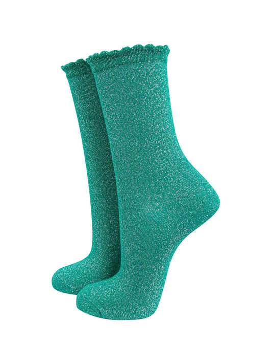green cotton socks with an all over silver glitter shimmer, the socks have a scalloped cuff edge