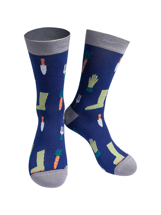 blue socks with grey heel, toe and cuff with a pattern of gardening tools, gloves, boots and carrots