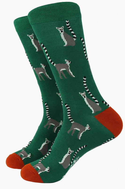 green bamboo dress socks with a pattern of grey lemurs all over, the socks have a burnt orange toe and heel