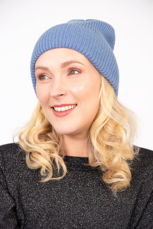 model wearing a light denim blue winter beanie hat
