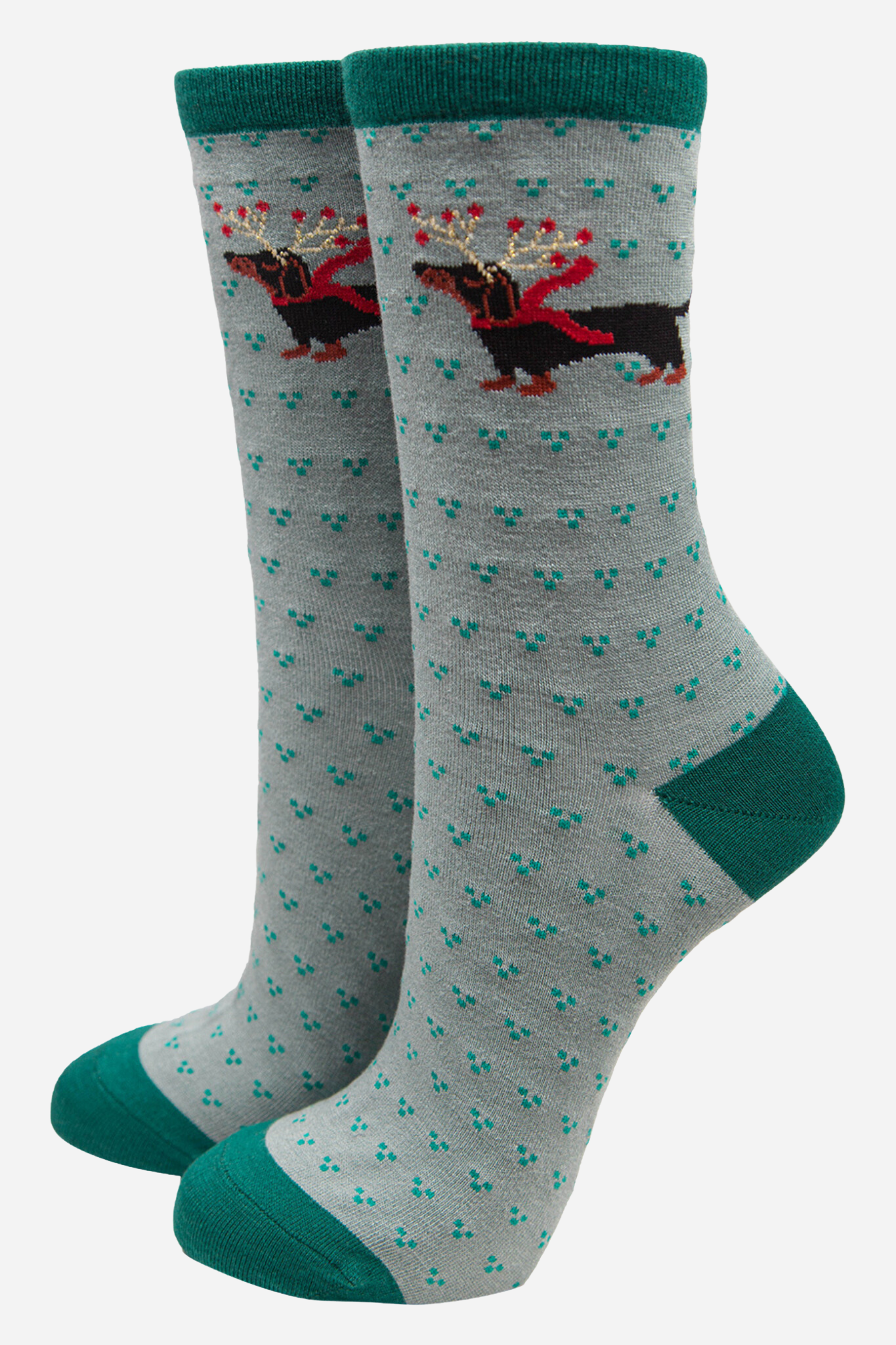 green bamboo ankle socks with green cuff, toe and heel with a large black sausage dog wearing reindeer antlers on the ankle of the socks