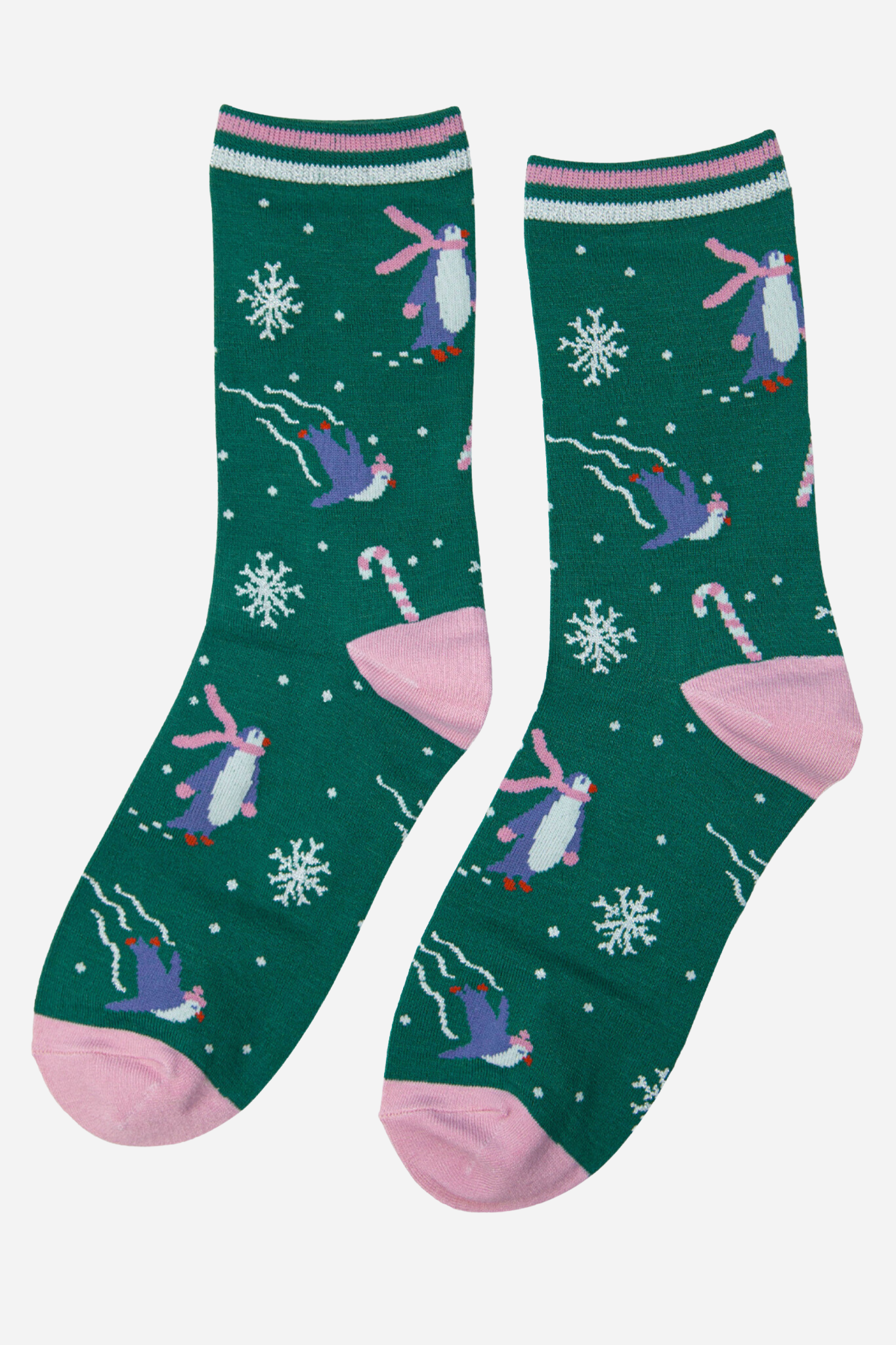 green and pink sparkly christmas socks with a pattern of snowflakes, penguins and candy canes