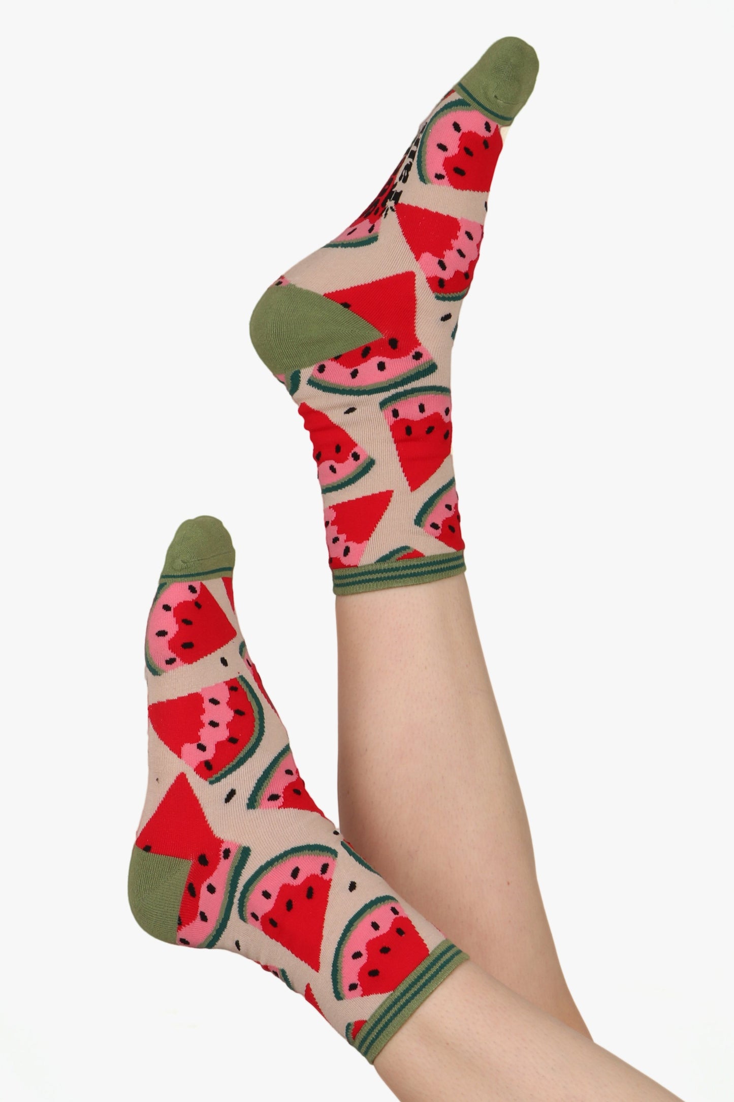 Ladies feet in the air wearing watermelon print socks with contrasting green toe, heel and cuff detail