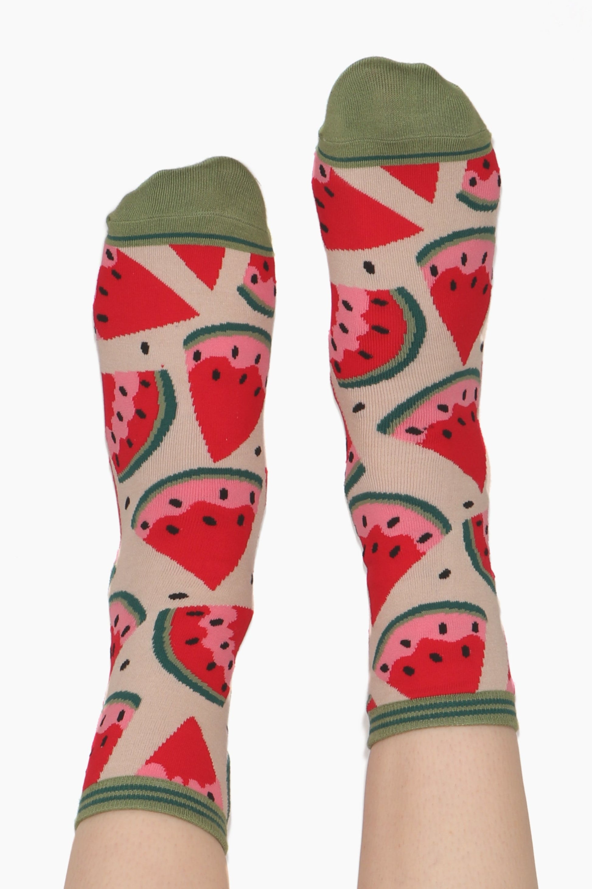 Ladies feet straight in the air wearing watermelon printed bamboo socks. Green contrasting toe and cuff an be seen
