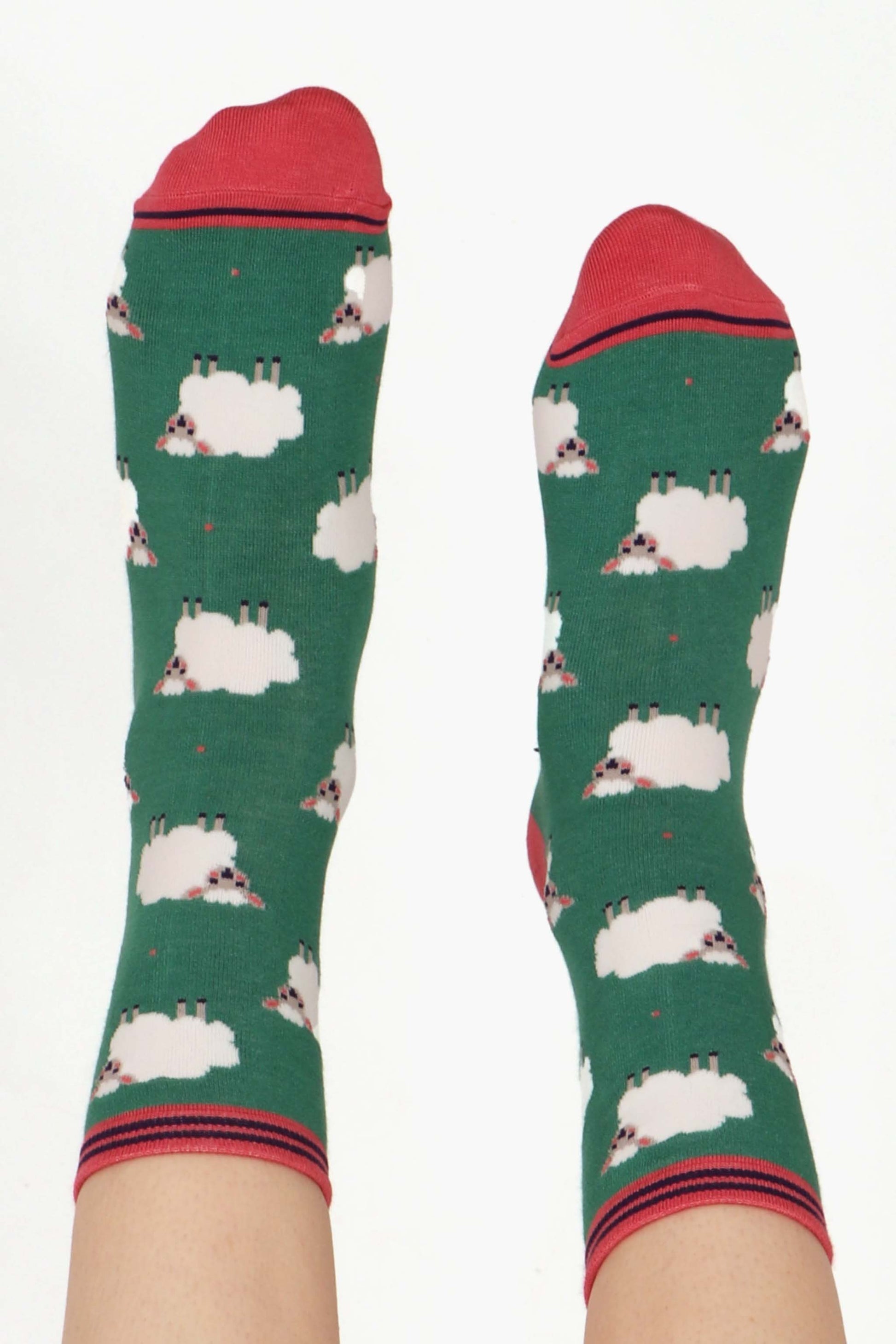 green ankle socks featuring a pattern of white woolly sheep lamb all over
