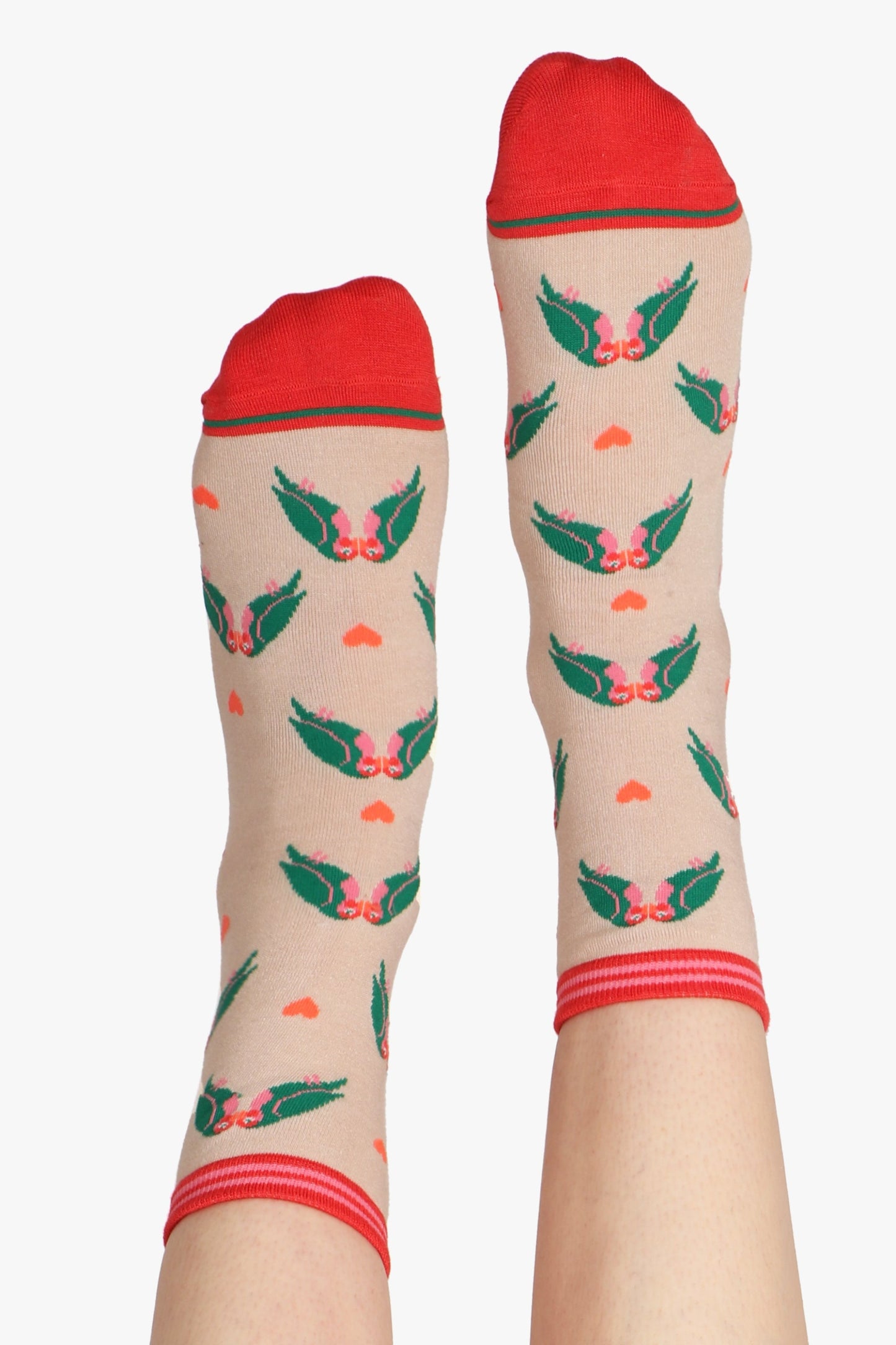 Ladies feet in air wearing lovebird print socks. Cuff and toe details can be seen