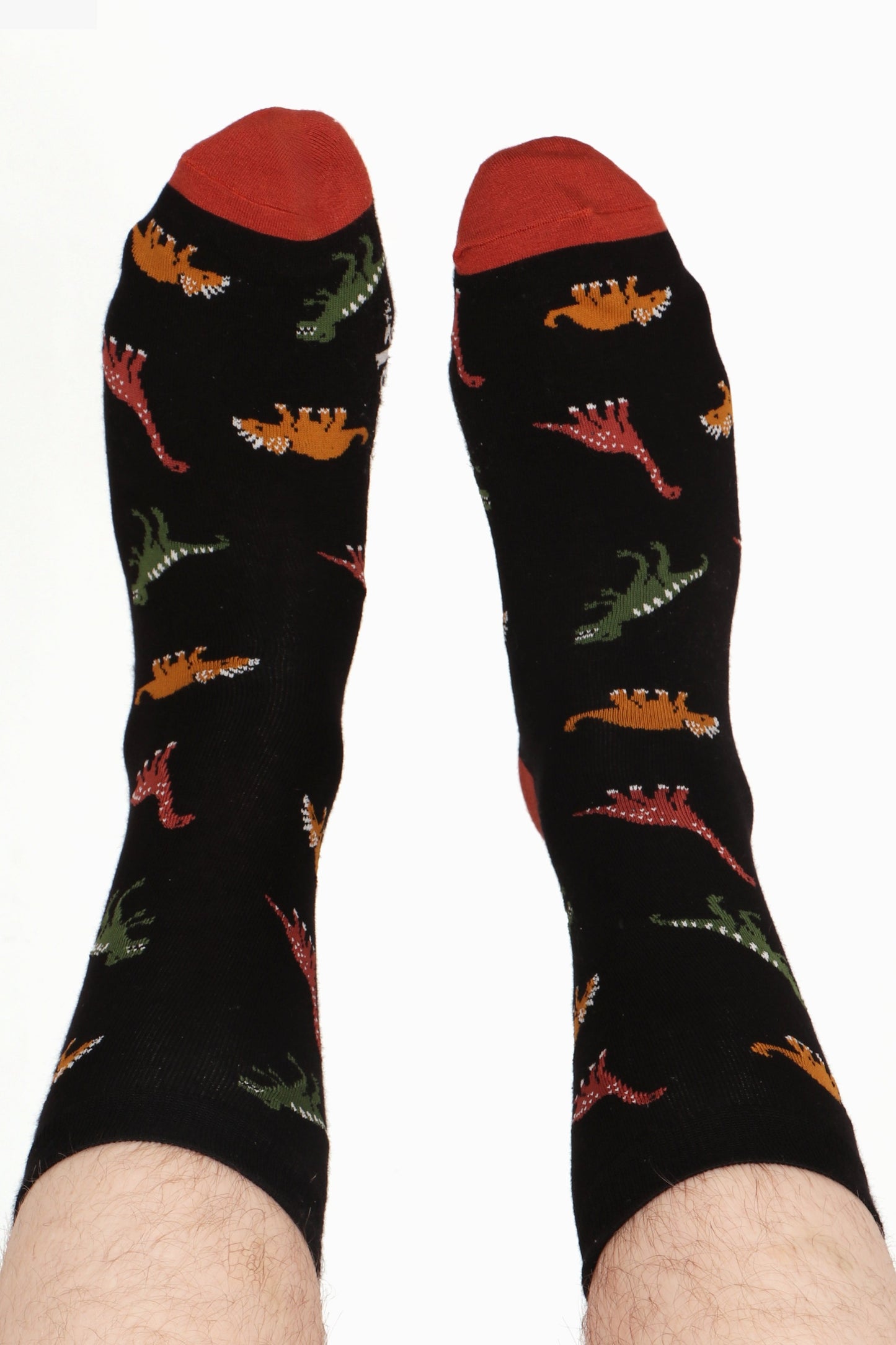 Men's feet in air. Dinosaur print can be seen along with contrasting terracotta tone tone detail