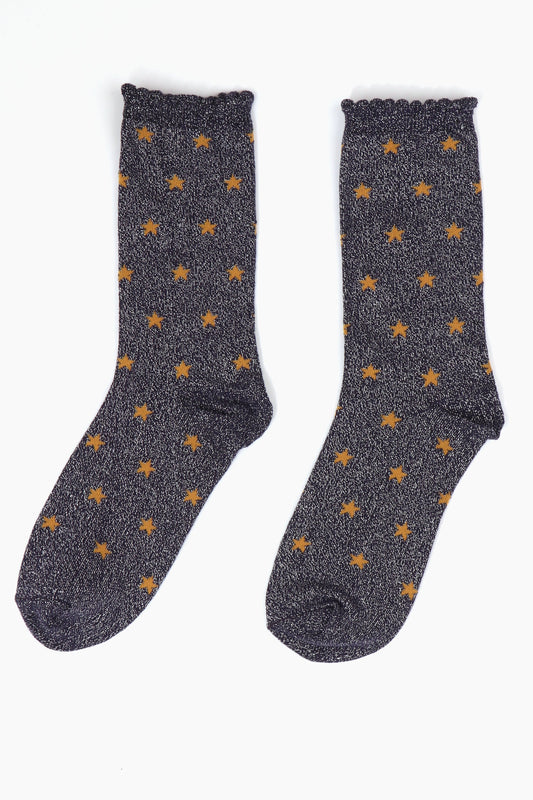 navy blue glitter socks with an all over star print pattern in orange, the socks have scalloped cuffs and a silver sparkle 