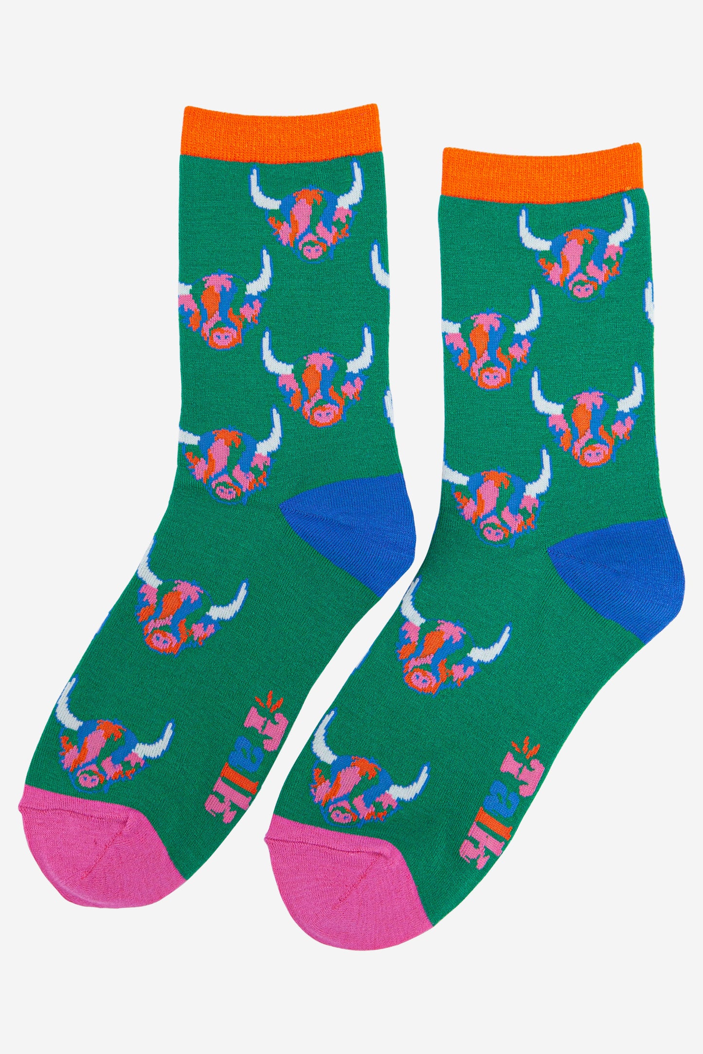 green ankle socks with an orange cuff, blue heel and pink toe with an all over pattern of multi-coloured highland cows