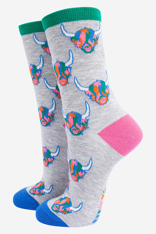 womens grey ankle socks with an all over pattern of multicoloured highland cow faces