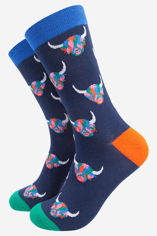navy blue dress socks with an all over pattern of multicoloured highland cows