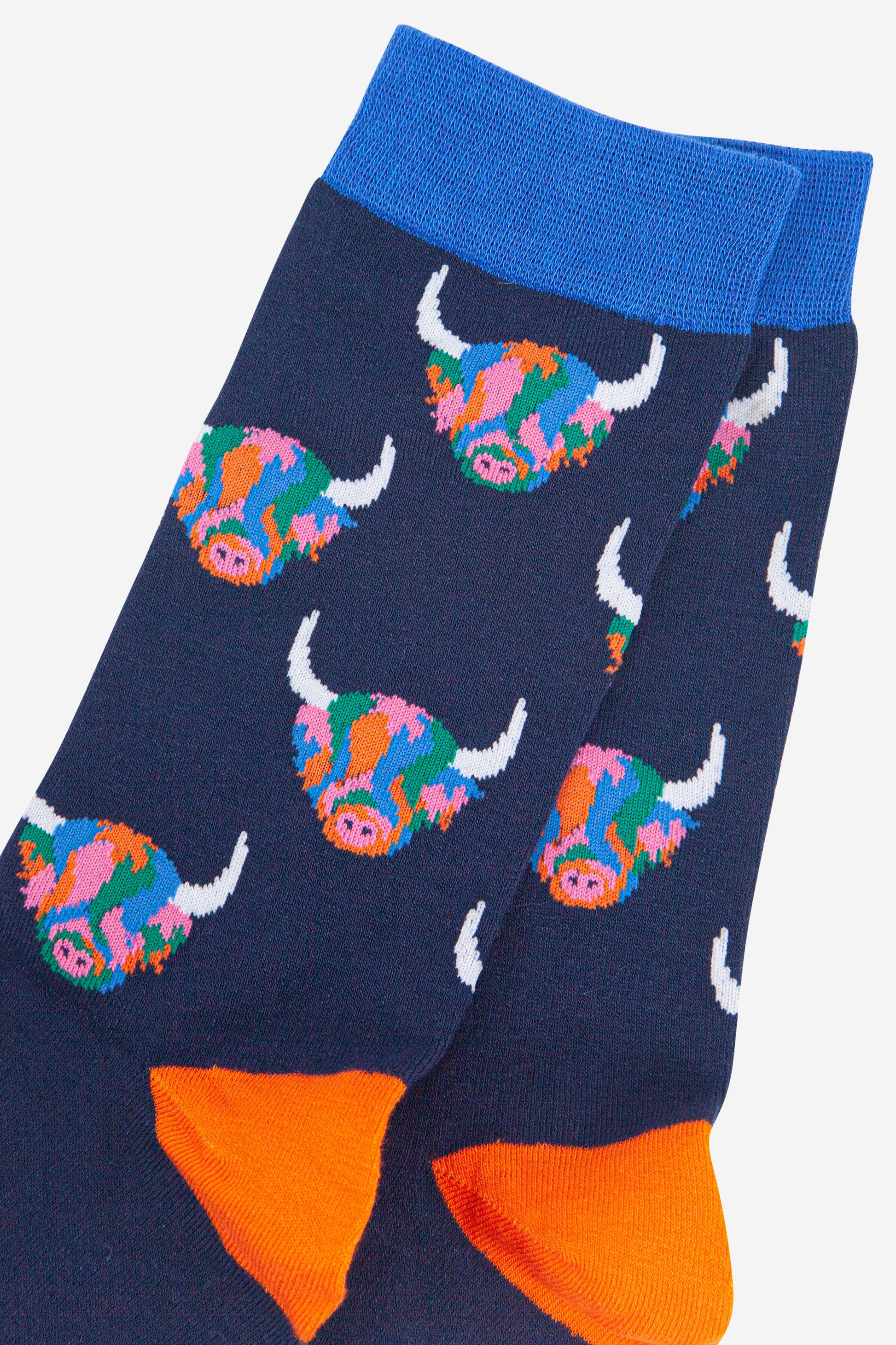 mens navy blue bamboo socks with an all over pattern of rainbow coloured highland cows