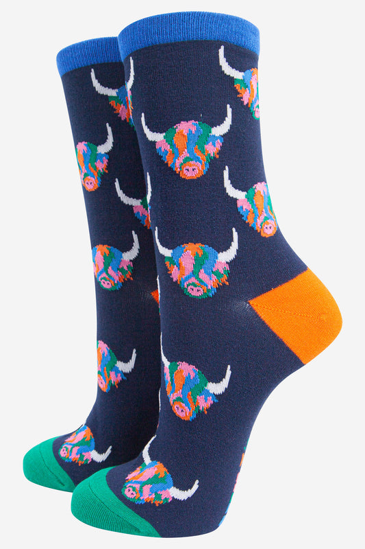 womens navy blue ankle socks with an all over pattern of multi-coloured highland cow faces