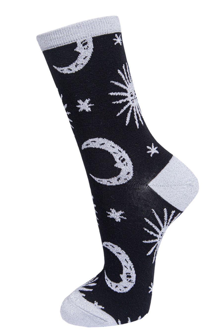 black socks with grey, stars, crescent moons and suns with silver sparkly glitter accents