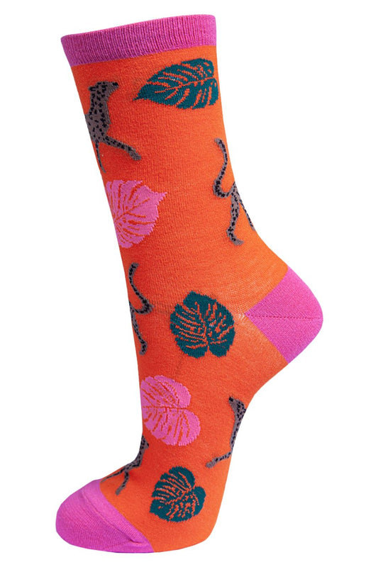 orange bamboo socks with pink and green leaves and brown cheetahs