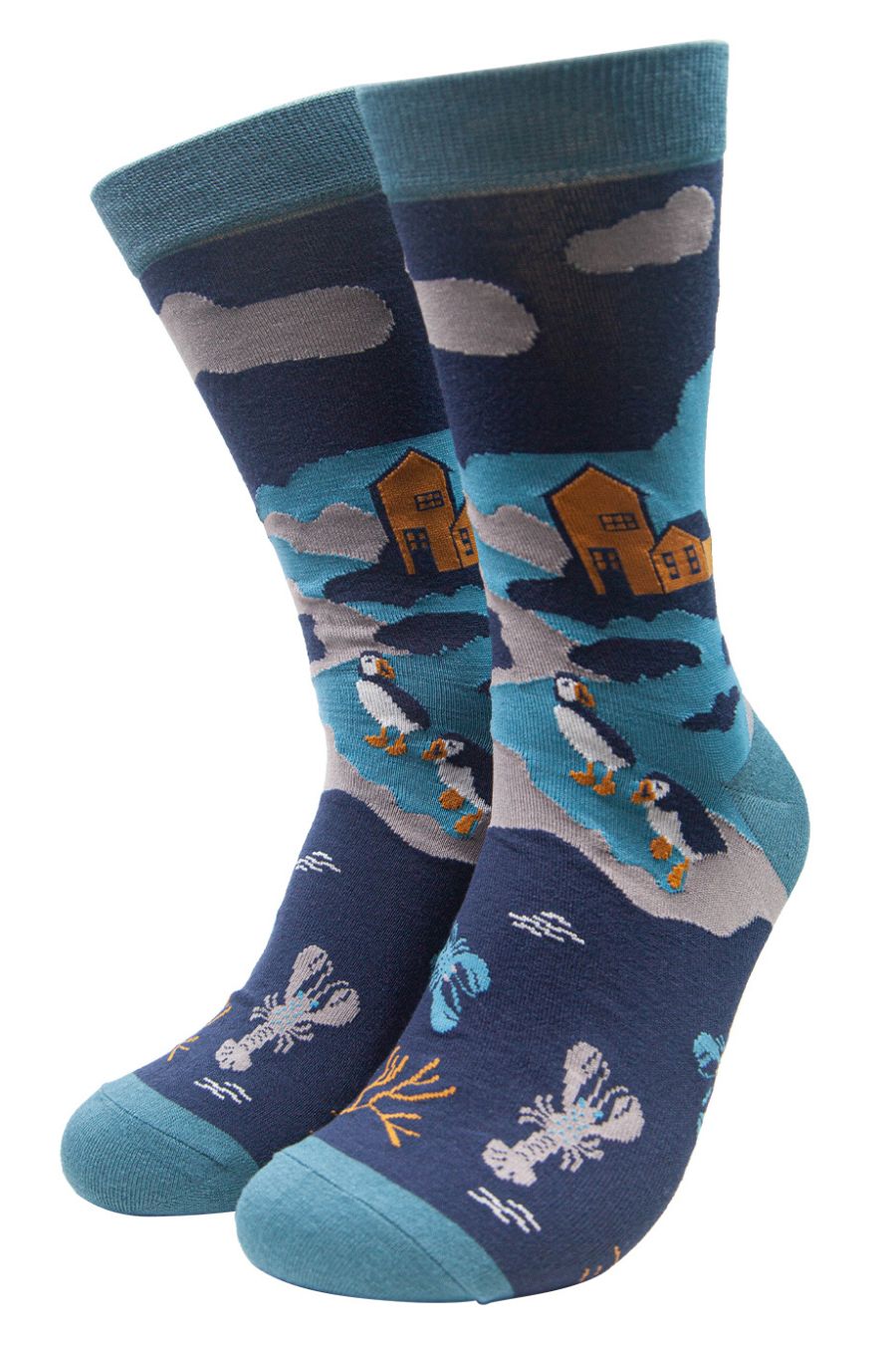blue socks designed to look like a shoreline with waves, lobsters, puffins and houses