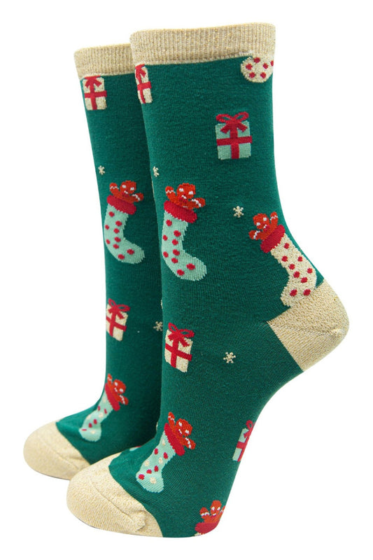 green bamboo socks with gold glitter heel, toe and trim with pattern of xmas stockings and gifts