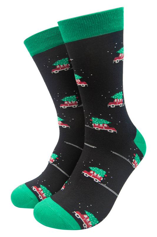 black and green bamboo socks with a pattern of a jeep carrying a xmas tree on its roof
