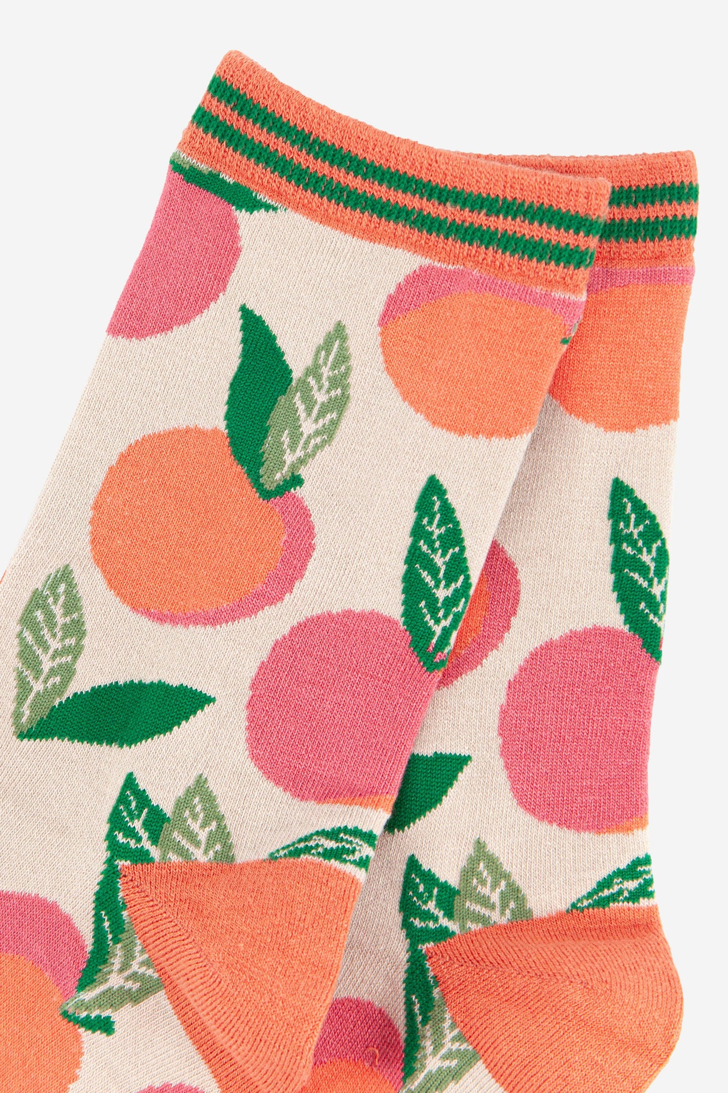 close up of the peaches pattern and striped cuff on the bamboo socks