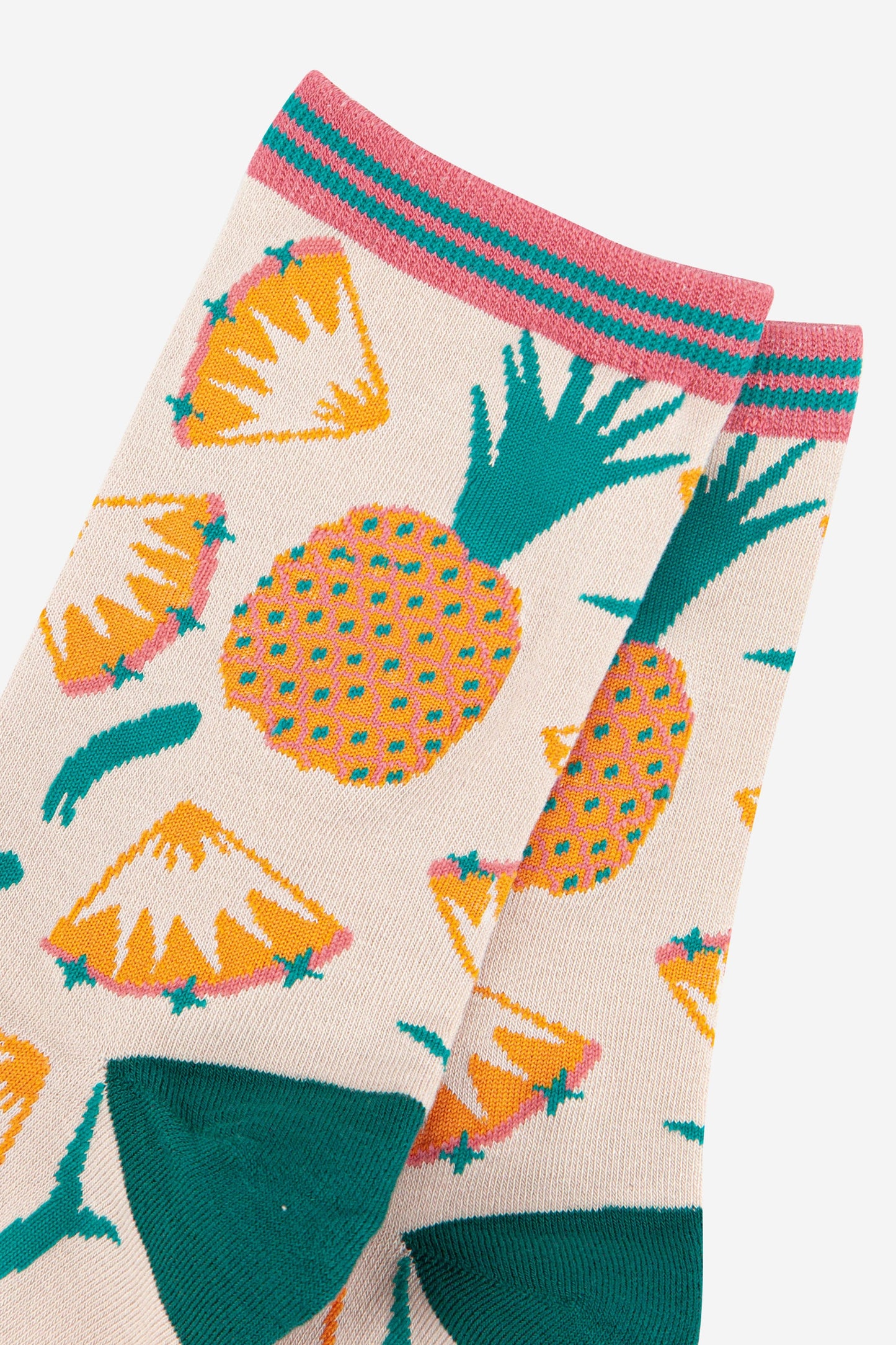 close up of the pineapple pattern on the socks, showing whole pineapples and pineapple slices