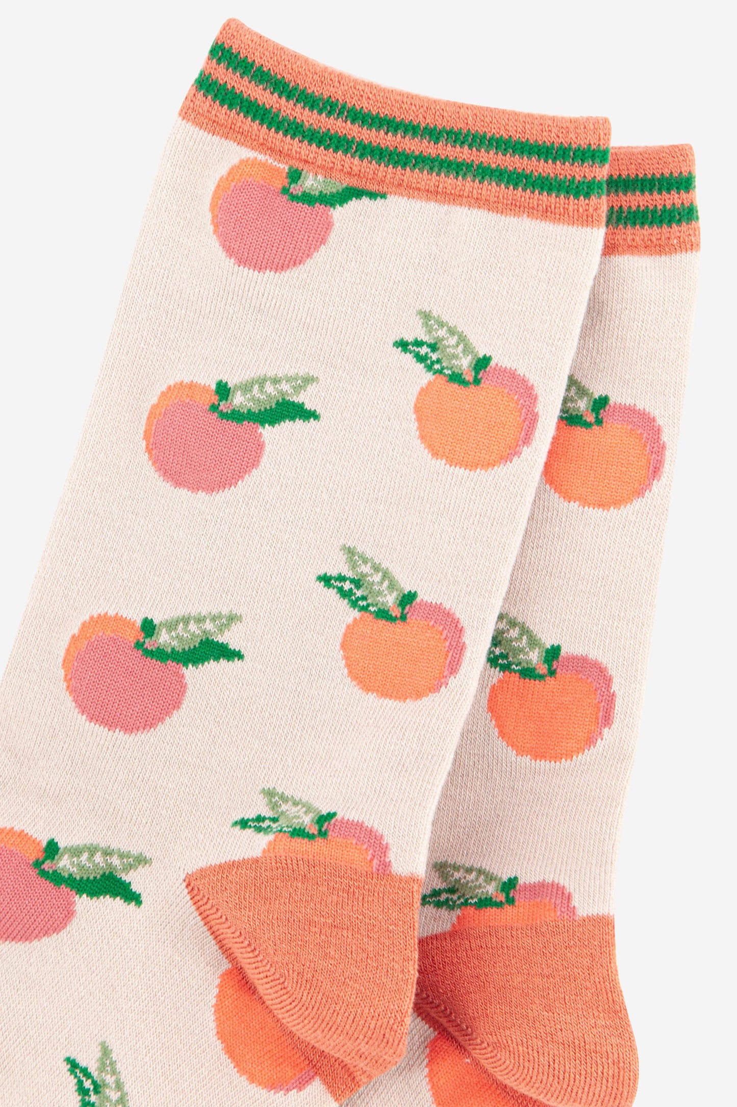 close up of the peach fruit pattern on the ankle of the socks