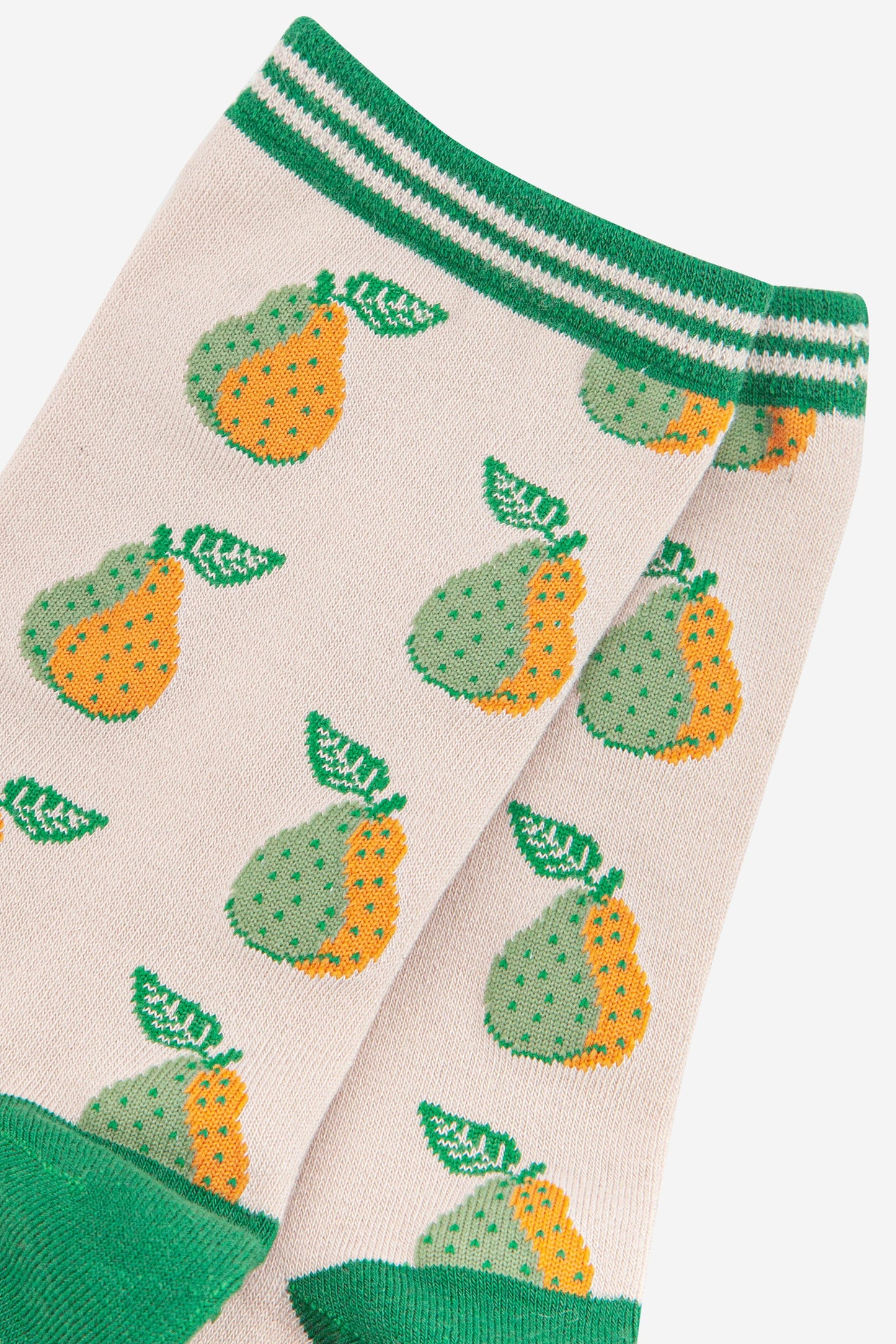 close up of the green and yellow pear fruit print  and striped cuff on the bamboo socks