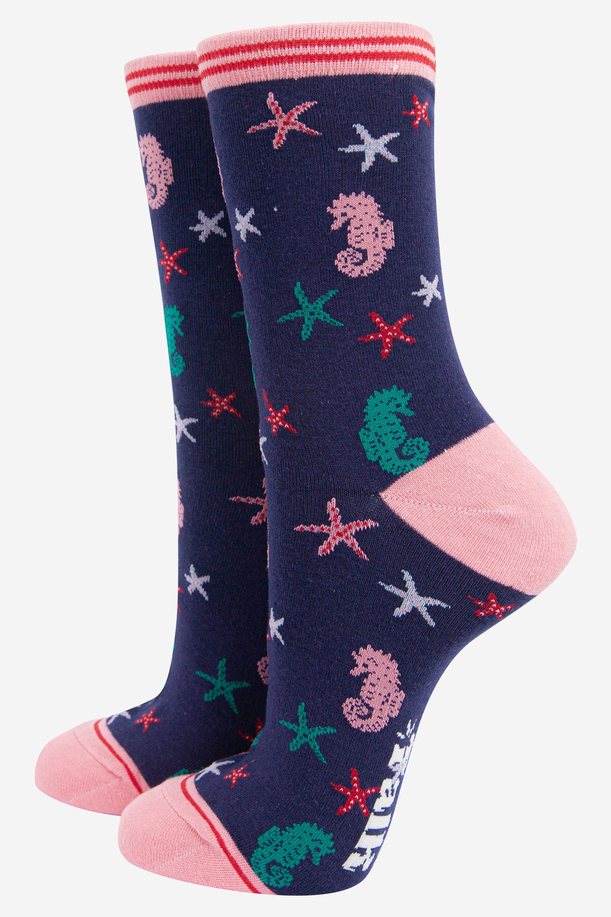 navy blue and pink ankle socks with an all over pattern of star fish and seahorses