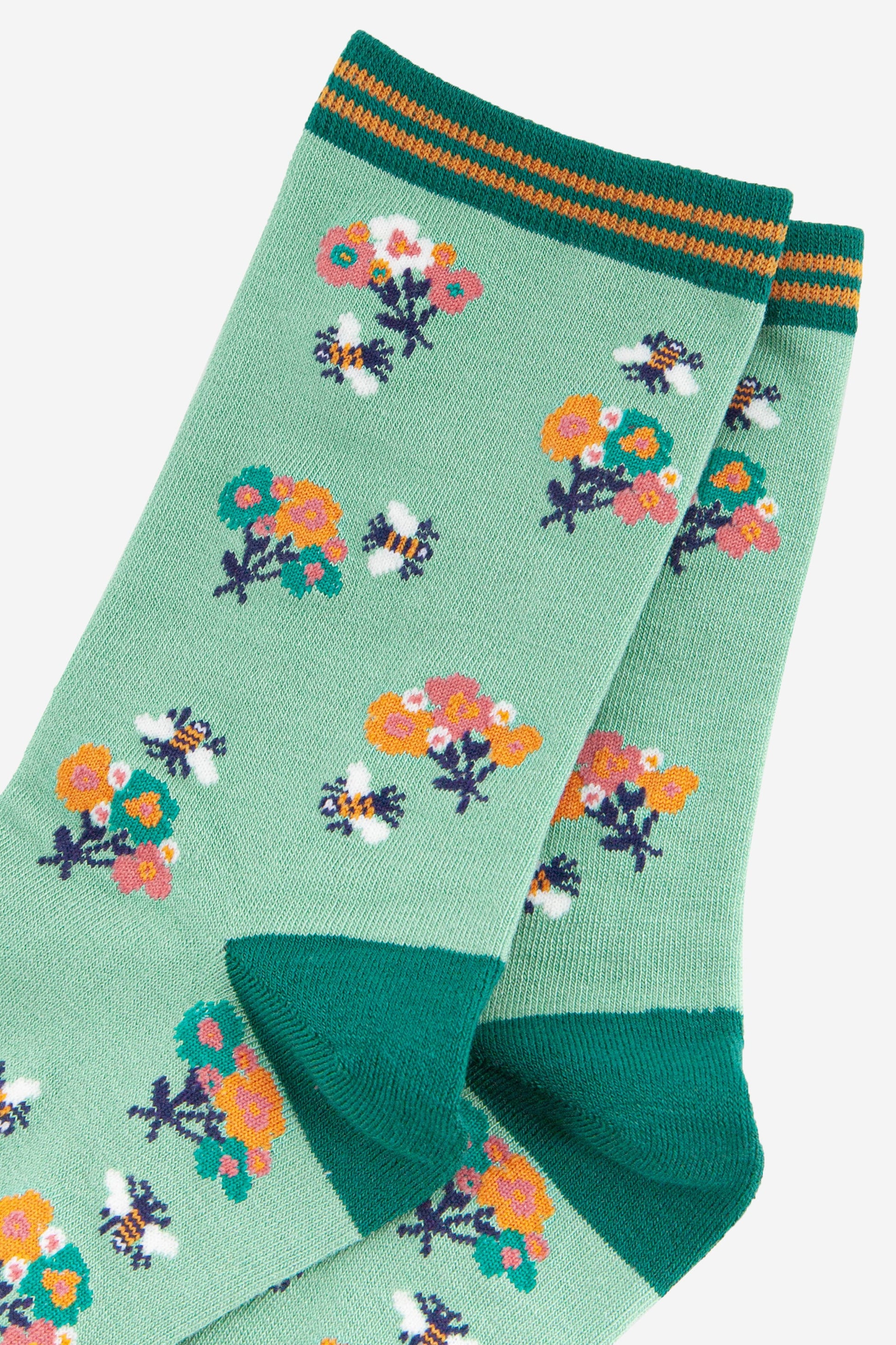 close up of the bee and floral pattern on the bamboo socks
