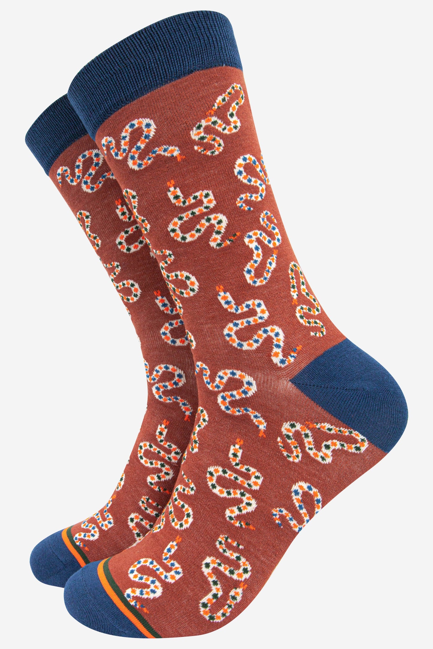 burnt orange bamboo socks with an all over pattern of winding rattle snakes and navy blue heel, toe and cuff