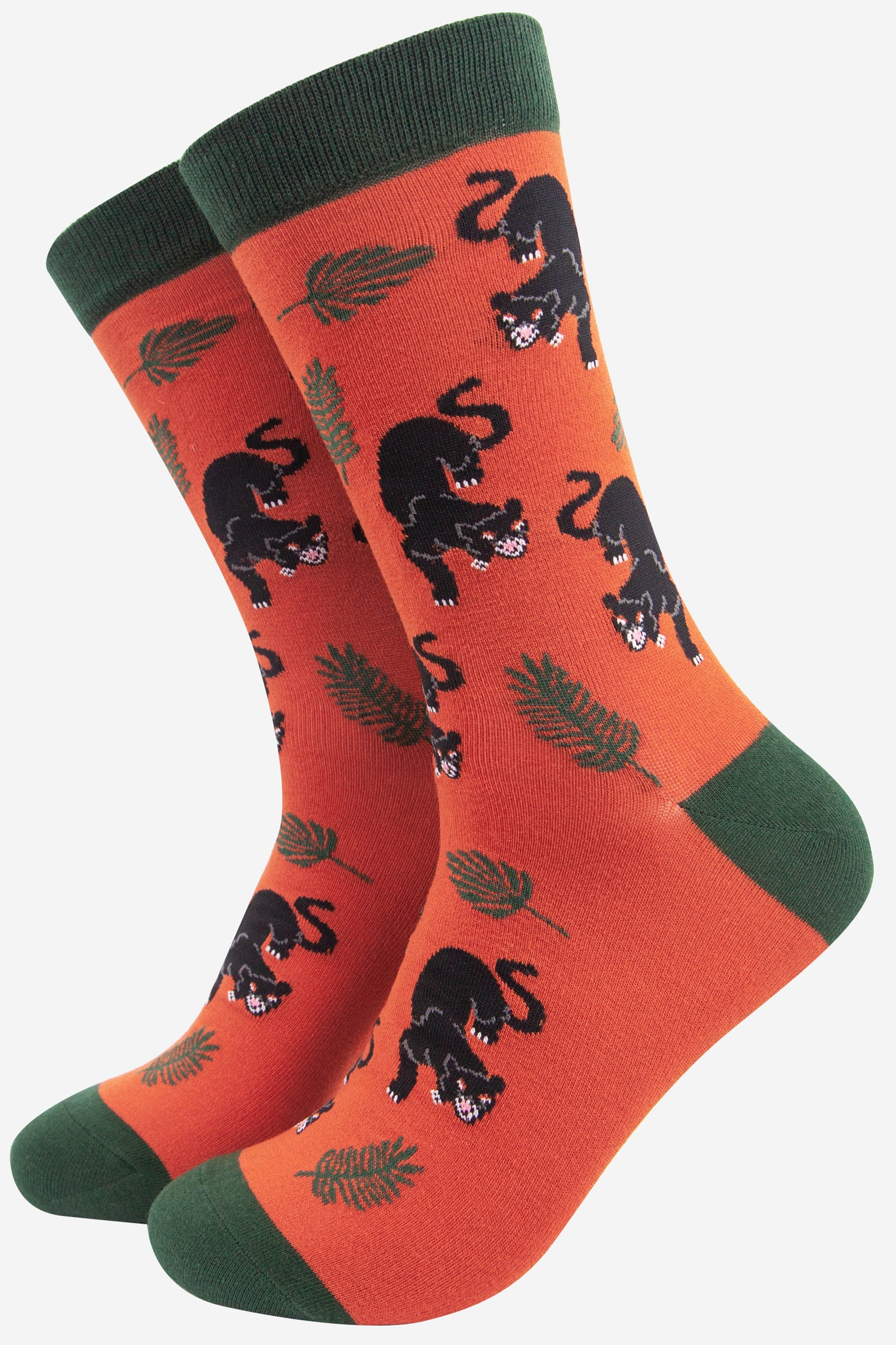 orange and green bamboo dress socks featuring a black panther big cat with a jungle leaf design