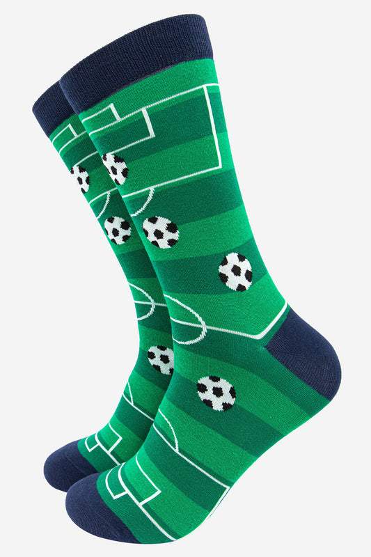 green socks designed to to look like a football pitch with black and white checked footballs