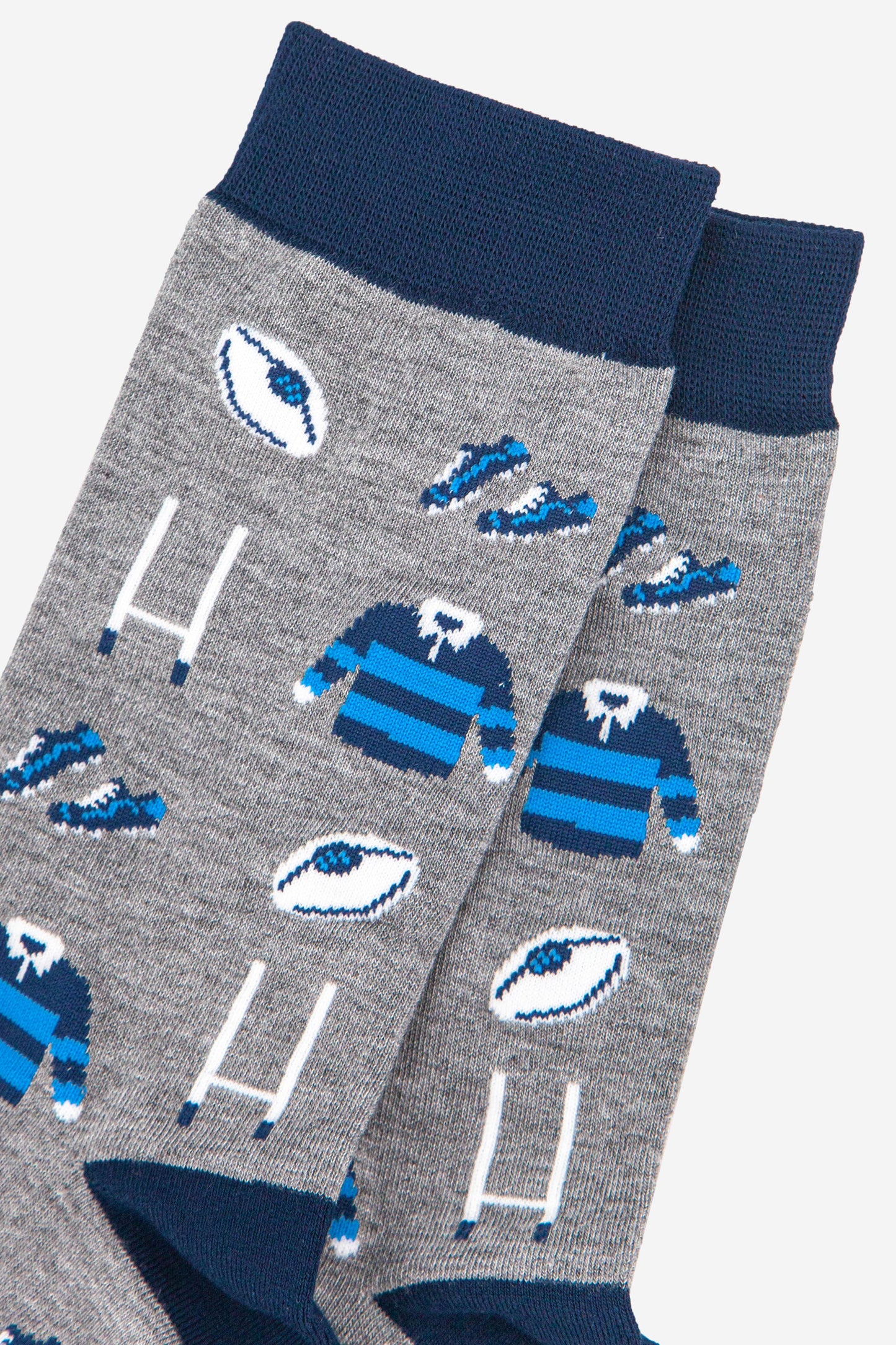 close up of the rugby goal post, ball and blue team kit pattern